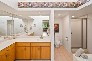 Bathtub, hair dryer, towels, shampoo