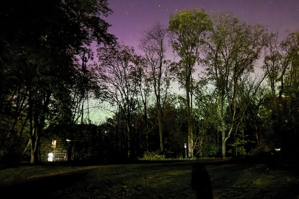 Cabin under the Northern Lights and Stars