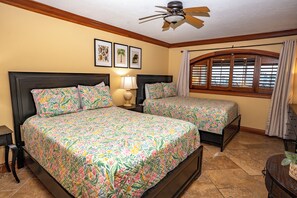 A hotel room with two beds, a ceiling fan, a window with blinds, and a nightstand with a lamp. - Unit 84- 1 Bedroom 1 Bathroom Condominium with Partial North Views. (Sarasota)