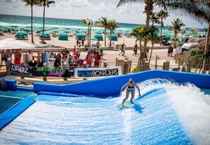 A person surfing on a wave in a water park.