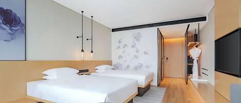 A modern hotel room with two beds, a large flat-screen TV, and a minimalist design.