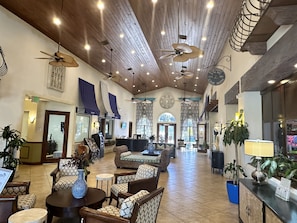 Experience the grandeur of our lobby, featuring a high ceiling with exposed beams, comfortable seating areas, and a reception desk.