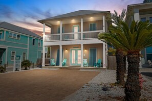 A two-story building with a balcony, a sign reading "INLAND TIME," and a palm tree in the foreground. - Island Time Large Private Pool Luxury Super Close Beach Access (Panama City Beach)