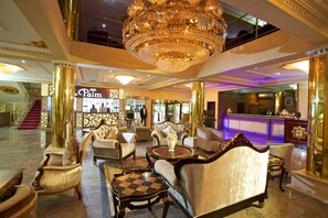 A luxurious lobby with ornate chandeliers, plush seating, and a reception desk. - Aridolf Resort Wellness and Spa (Yenagoa)
