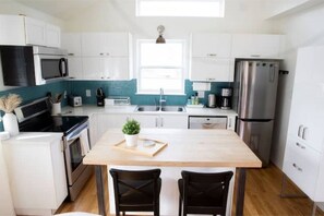 Enjoy cooking in this kitchen with a central island, sink, and oven.