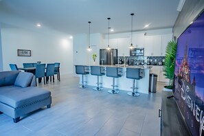 Relax in a stylish living area with a sofa set, dining table, and kitchen area.