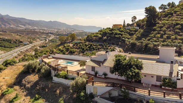 A residential area with a pool, a view of a highway, and distant mountains. - Stunning home in Torrox (Torrox)