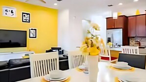 A modern dining area with a white table set for four, yellow placemats, and a vase with flowers. - Universal Studios.Townhome.3BR.Private Pool! (Davenport)