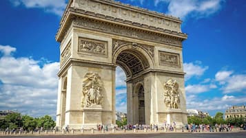 The Arc de Triomphe in Paris, featuring classical architecture and detailed sculptures.