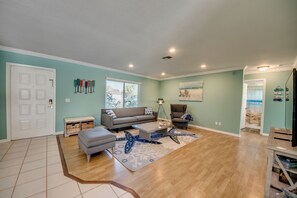 Relax in this inviting living room with a sofa, coffee table, and patterned rug.