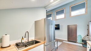 A modern kitchen with a stainless steel refrigerator, wooden countertop, and a built-in sink. - Old Forge Studio: Close to Lakes & Hiking Trails (Old Forge)