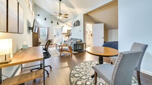 A spacious living area with a wooden dining table, a sofa, and a ceiling fan. - Old Forge Studio: Close to Lakes & Hiking Trails (Old Forge)