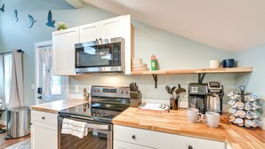 A modern kitchen with white cabinets, stainless steel appliances, and wooden countertops. - Old Forge Studio: Close to Lakes & Hiking Trails (Old Forge)