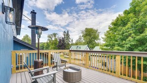 A deck with a metal heater, two chairs, and a round wicker table. - Old Forge Studio: Close to Lakes & Hiking Trails (Old Forge)