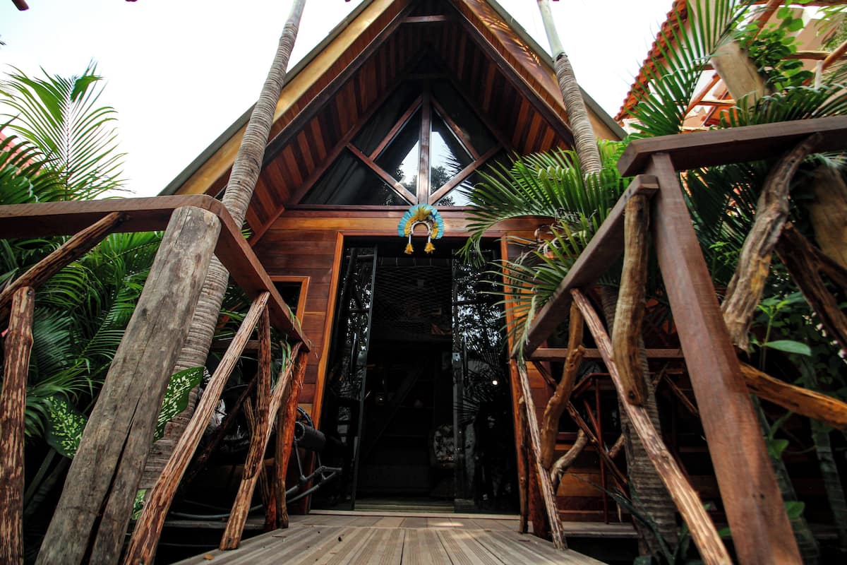 A wooden structure with a triangular roof and a central doorway.