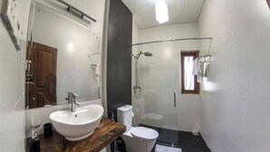 A compact bathroom with a sink, toilet, and shower. - Coco Villa Peach Tree (Seeduwa - Katunayake)