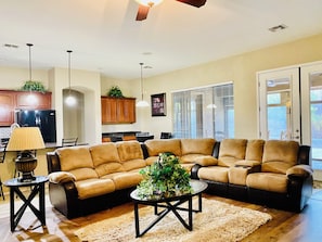 Relax in this inviting living room with a large sofa, coffee table, and cozy rug.
