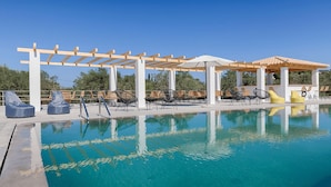 A pool area with lounge chairs and a pergola structure. - BRISOT Hotel Galatas Poros (Poros)
