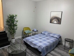 Enjoy a restful stay in this stylish room with a neatly made bed, a single chair, and a small table.