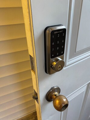 Secure entry with a modern electronic keypad lock and classic brass doorknob.
