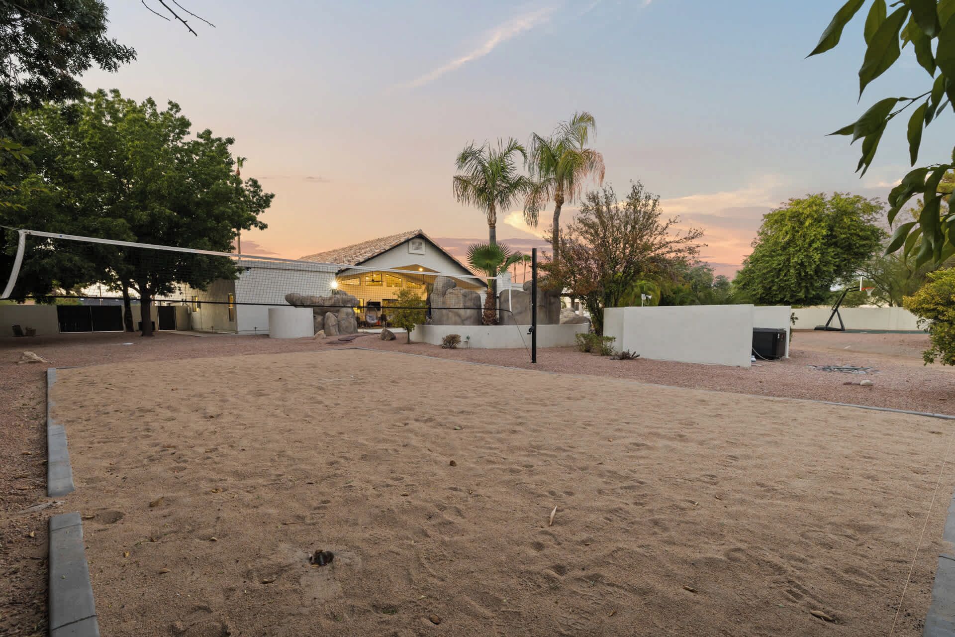 A sandy outdoor area with a building in the background.
