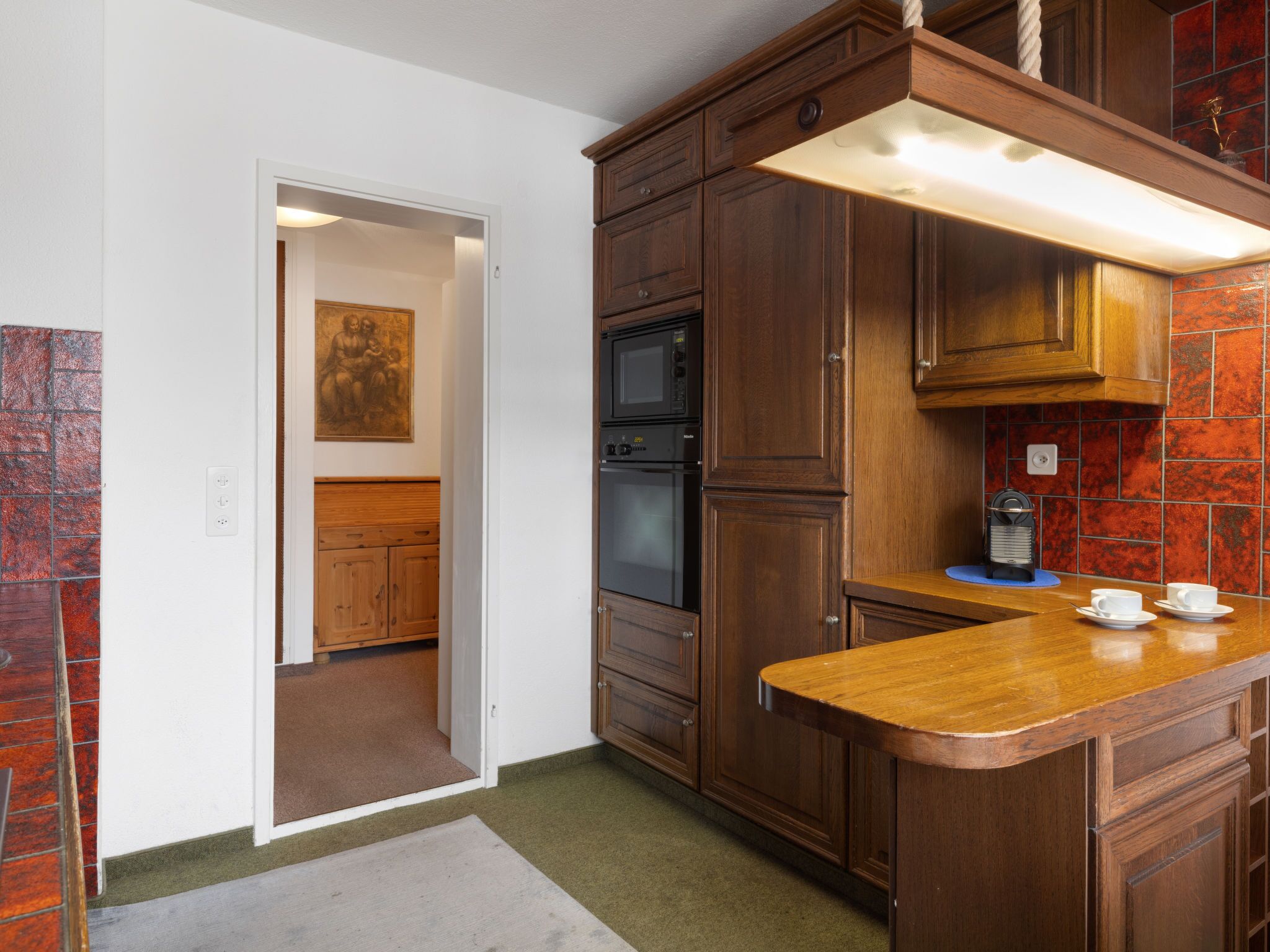 A kitchen with wooden cabinets, a microwave, and a coffee maker.