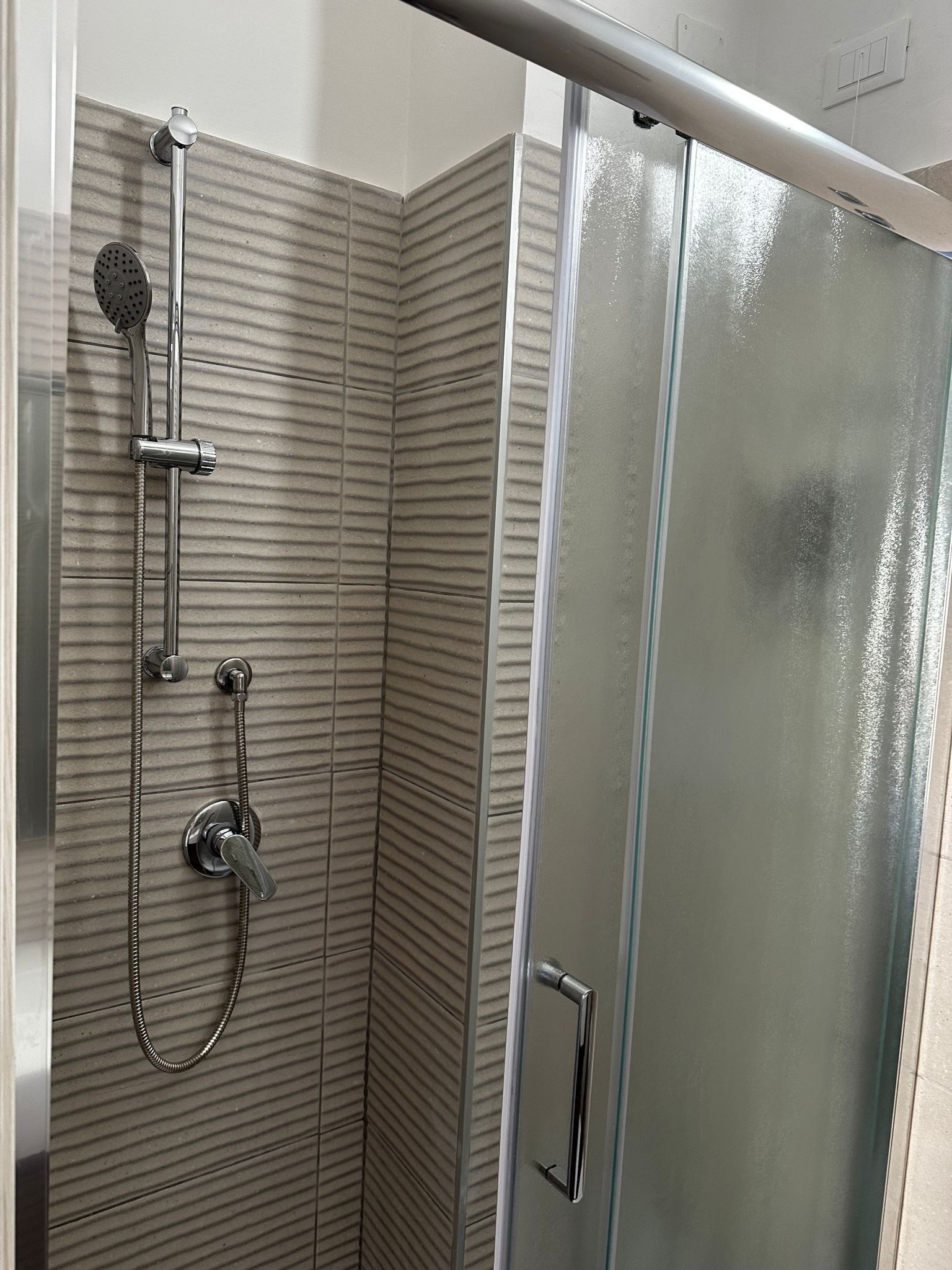 Shower, rainfall showerhead, hair dryer, towels