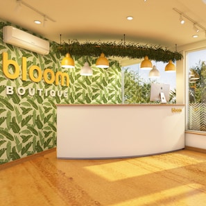 Welcome to Bloom, where a curved reception desk and leafy patterned walls create a warm atmosphere.