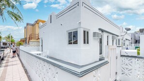 A white building with a balcony, a gate, and a satellite dish. - Hot Location-New Studio for 2-Beach-Margaritaville (Hollywood)