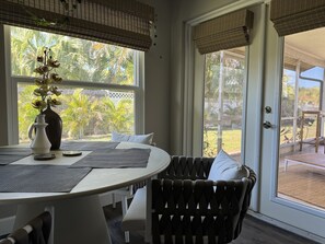 Enjoy a serene view of the lush garden from the large window in this stylish room.