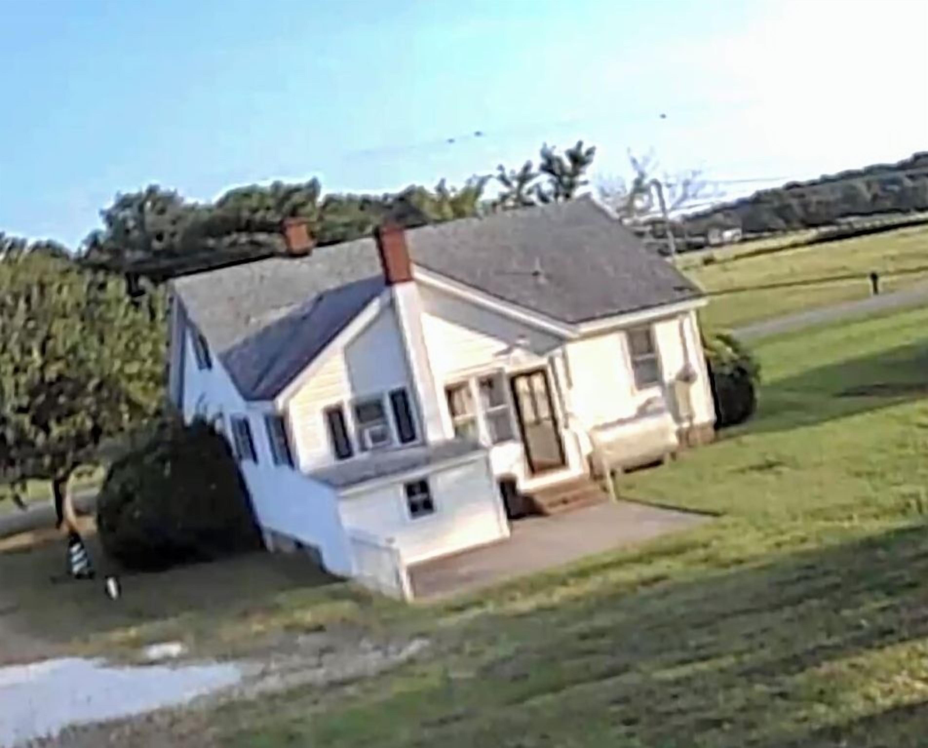 A single-story house with a sloped roof, a front porch, and a small front yard.