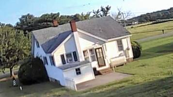 A single-story house with a sloped roof, a front porch, and a small front yard.