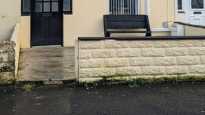A two-story building with a beige exterior, a black front door, and a satellite dish. - Fantastic Location to Ebrington Sq and City Centre (Londonderry)