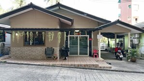 A small building with a tiled entrance, a covered porch, and a few potted plants. - Getaway near Patong Beach, shops and restaurants. Homey, private, and memorable. (Tambon Patong)