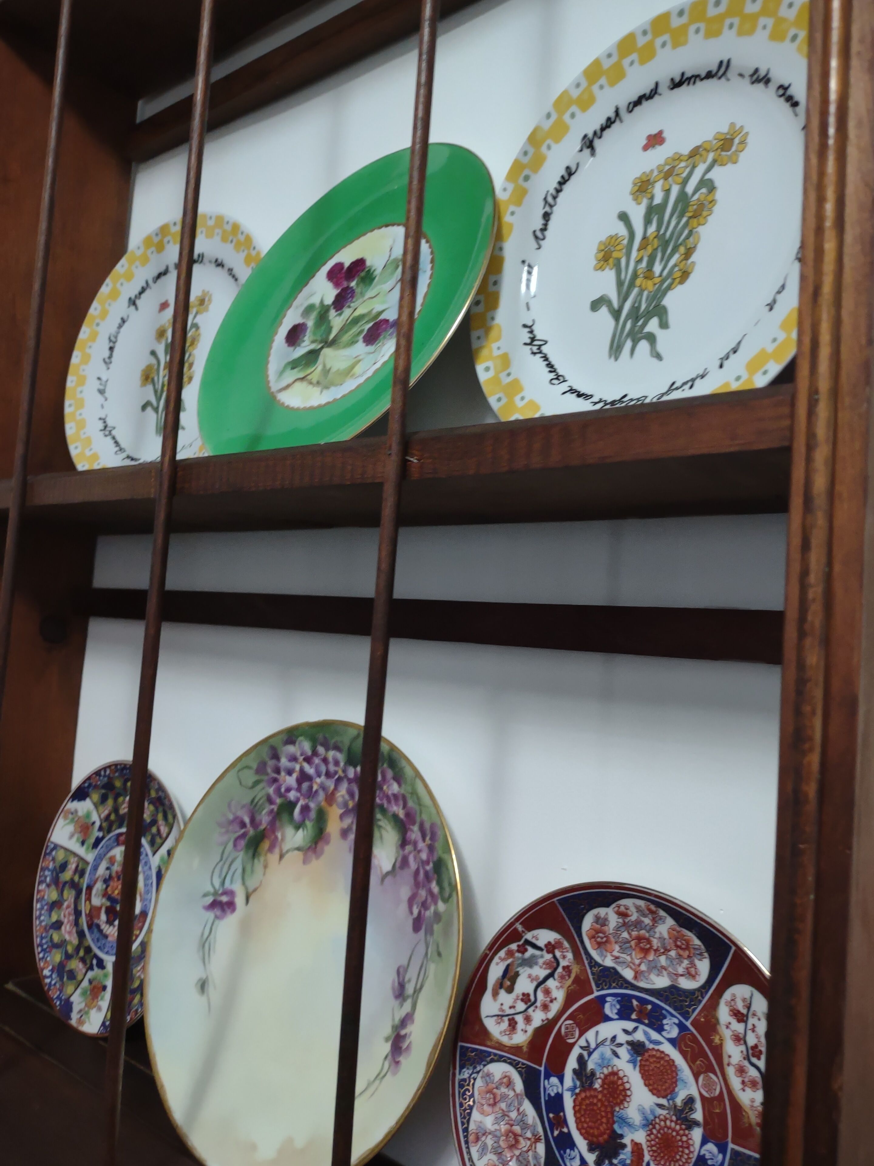 A display of various ceramic plates with floral designs.
