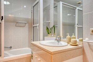 Bathtub, hair dryer, towels, soap