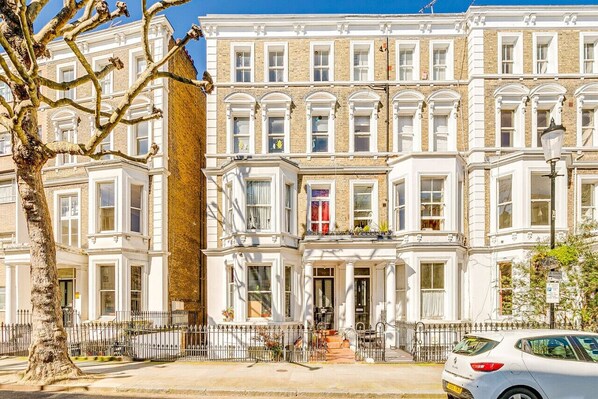 Classic architecture with a central entrance and balcony.