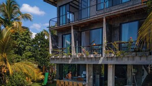 A modern two-story house with a pool, outdoor seating, and lush greenery. - Gaia Soul  (Maaliyadda)