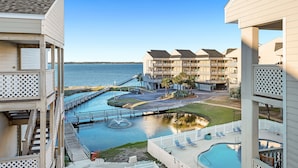 A hotel with a pool, a water feature, and a view of the water.
