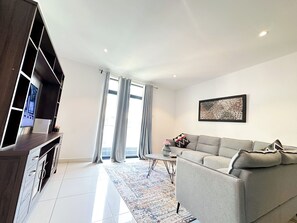Deluxe Room, 1 Bedroom, Accessible, Pool View | Living area | 50-inch Smart TV with digital channels - Embassy Gardens (Accra)