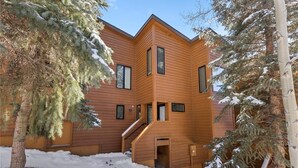 A modern wooden cabin with a central staircase and large windows. - One block to Keystone Conference Ctr: 2-BR townhouse, king beds, pool, hot tub (Keystone)