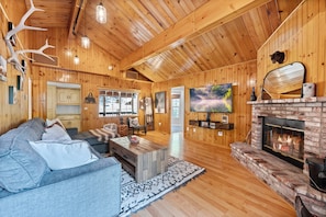 Cozy living room with a fireplace, television, and comfortable seating area.