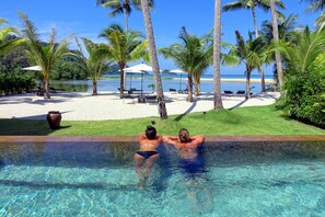 Una piscina al aire libre, sillones reclinables de piscina