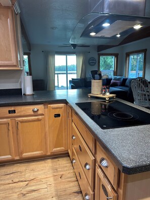 A kitchen with wooden cabinets, a granite countertop, and a built-in stove.