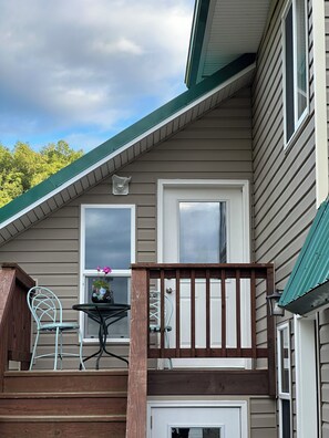 A house with a covered porch, a door, and a window.