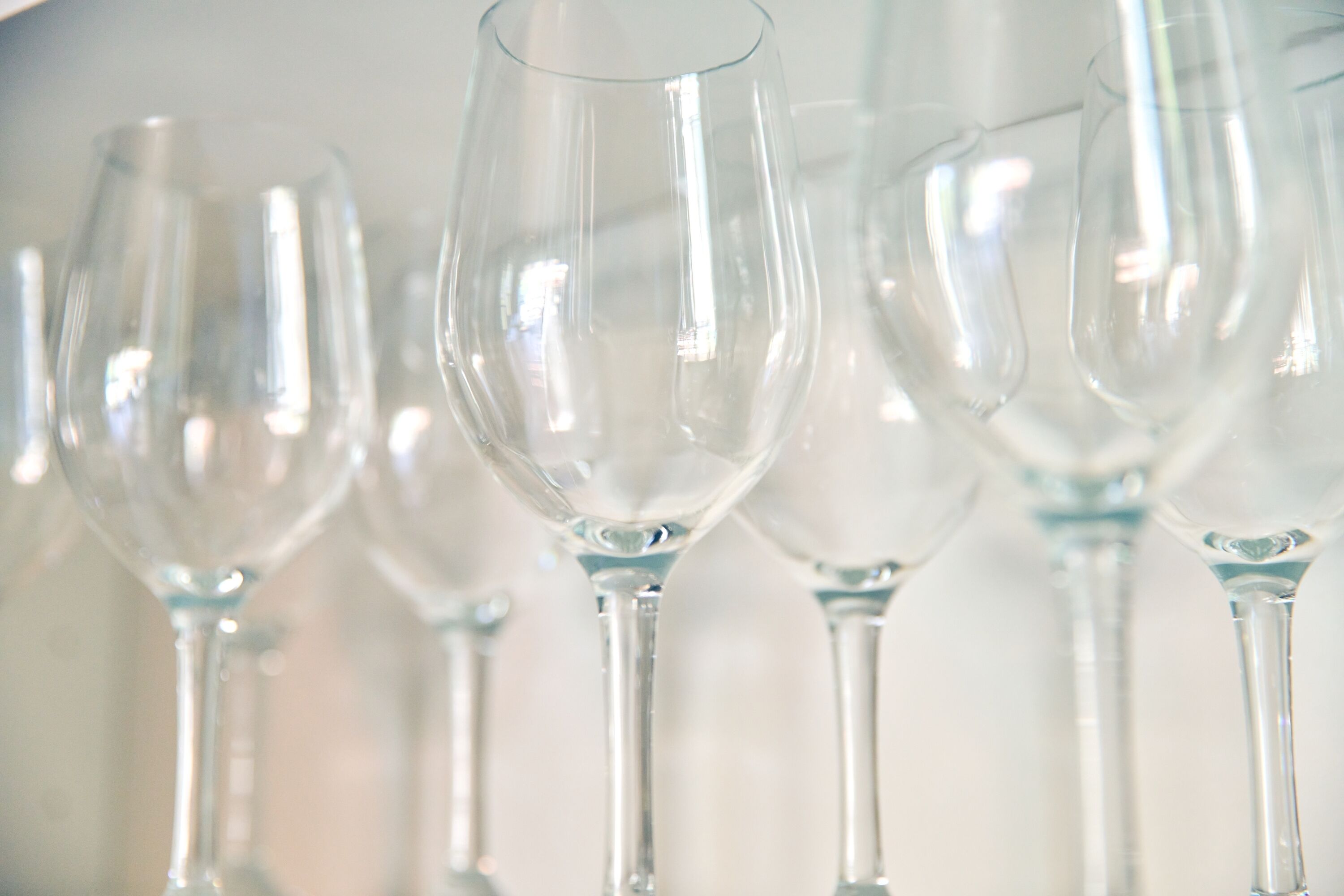 Vários copos de vinho vazios em linha.