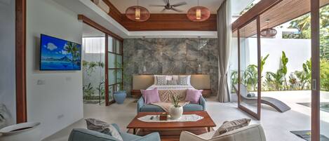 Un dormitorio moderno con pared de piedra, cama con vistas y ventana grande.