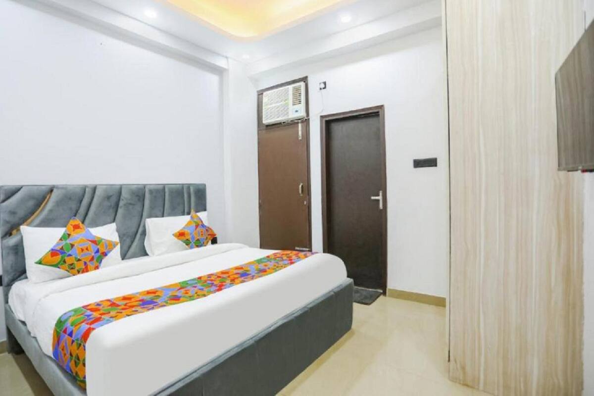 A bedroom with a bed, a wardrobe, and a door.
