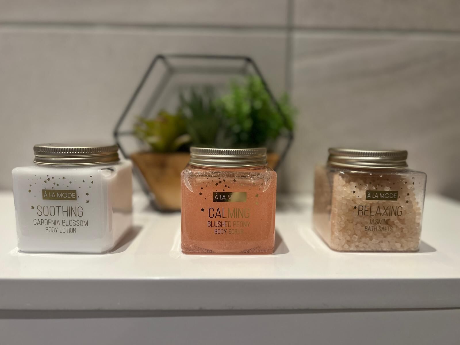 Three jars labeled 'SOOTHING', 'CALMING', and 'RELAXING' on a shelf.
