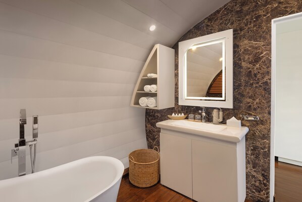 A modern bathroom with a freestanding bathtub, a vanity with a mirror, and a marble backsplash. - BOLAGALA AGRO FLOATING RESORT (Katana)